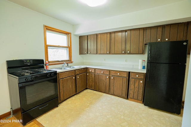 kitchen featuring sink and black appliances