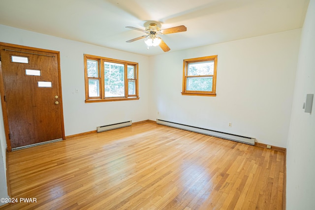 foyer with ceiling fan, light wood-type flooring, and a baseboard heating unit