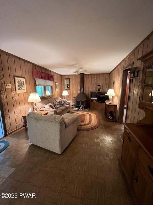 259 Florence Trl, Hawley, PA 18428 - living area with a wood stove, wooden walls, and a ceiling fan