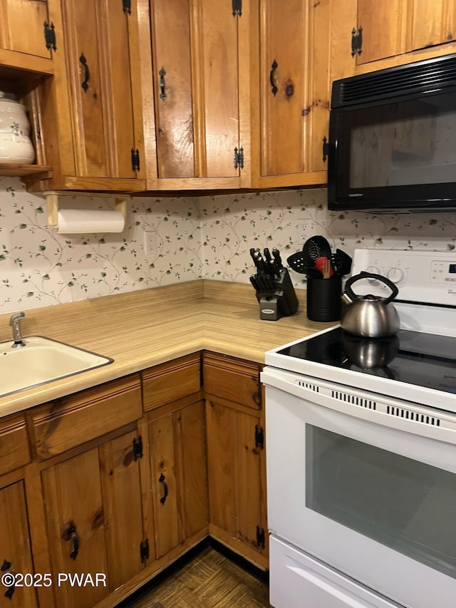259 Florence Trl, Hawley, PA 18428 - kitchen with electric stove, black microwave, light countertops, brown cabinetry, and backsplash
