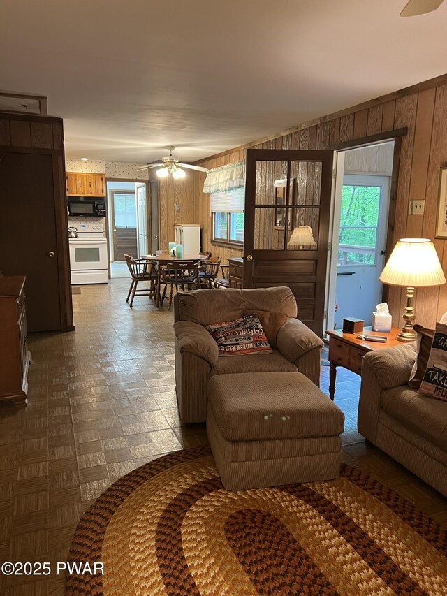 259 Florence Trl, Hawley, PA 18428 - living room with ceiling fan and wood walls