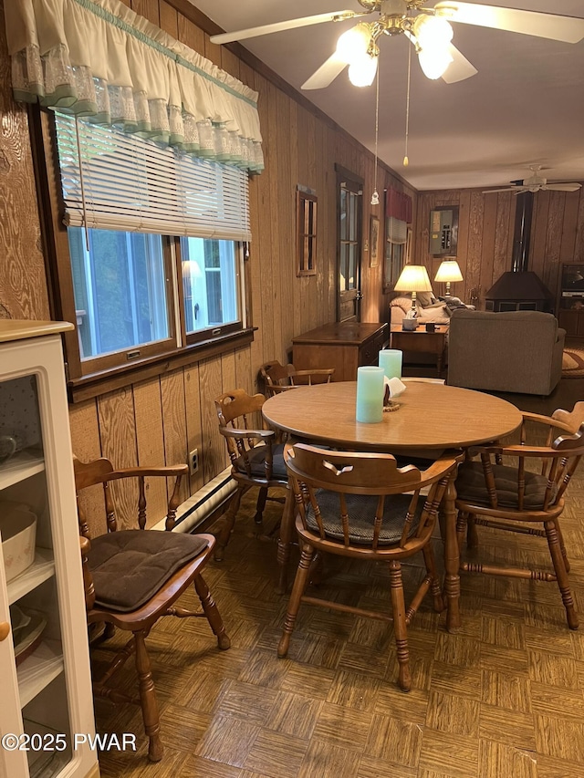 259 Florence Trl, Hawley, PA 18428 - dining room with wood walls, ceiling fan, and baseboard heating