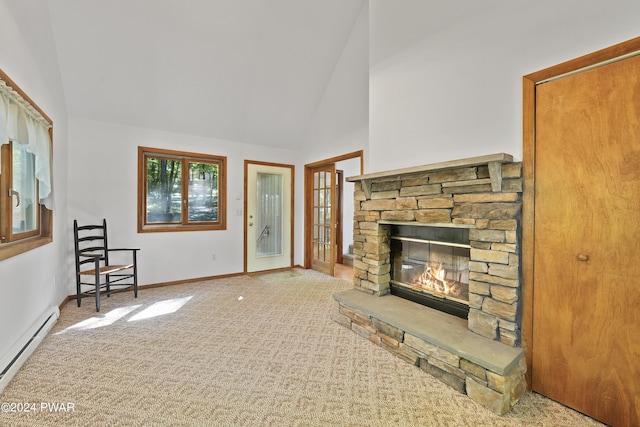 unfurnished living room with carpet flooring, a fireplace, high vaulted ceiling, and a baseboard heating unit