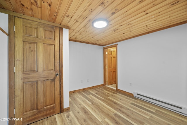 spare room with crown molding, wood ceiling, light hardwood / wood-style flooring, and a baseboard radiator