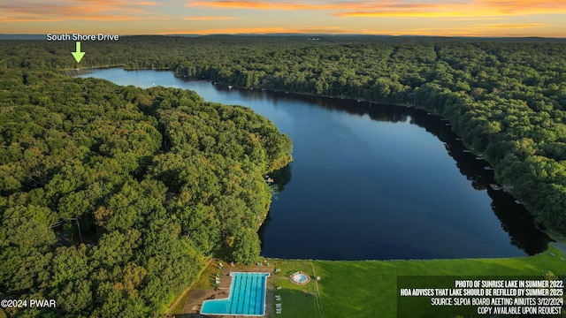 aerial view at dusk with a water view