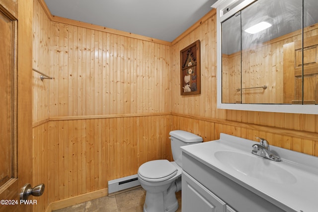 bathroom with vanity, wood walls, toilet, and a baseboard radiator