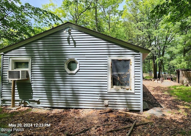 view of side of home featuring cooling unit