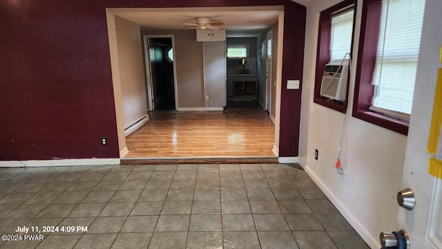 interior space with a baseboard radiator, tile patterned floors, and cooling unit