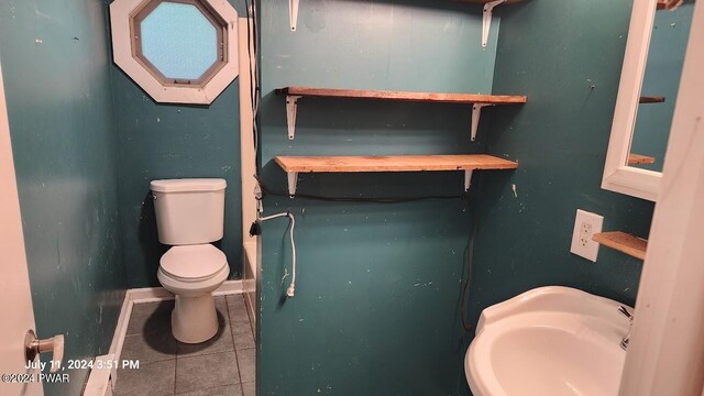 bathroom with tile patterned floors, sink, and toilet