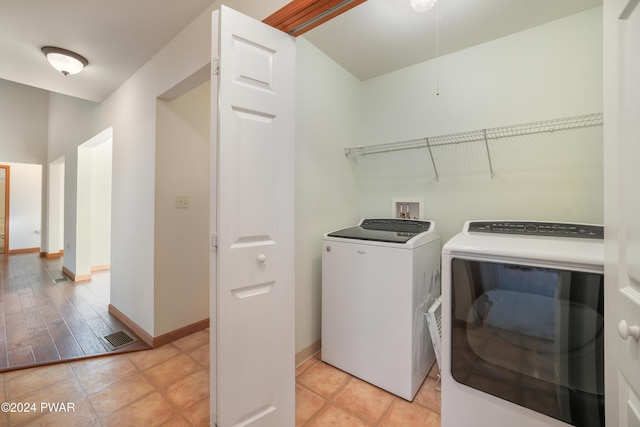 clothes washing area with washing machine and dryer