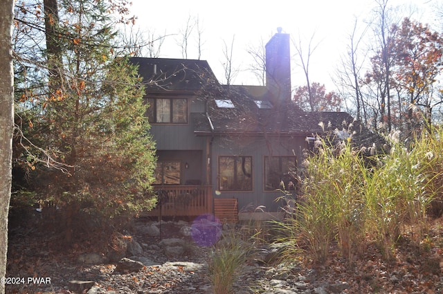 123 Fern Dr, Canadensis, PA 18325 - rear view of property with a shingled roof and a chimney