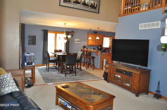 123 Fern Dr, Canadensis, PA 18325 - living room with a chandelier, light colored carpet, and baseboards