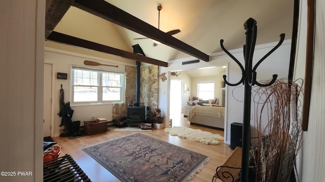 213 Powderhorn Dr, Lackawaxen, PA 18435 - bedroom with a wood stove, wood finished floors, and multiple windows