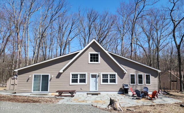 213 Powderhorn Dr, Lackawaxen, PA 18435 - back of house featuring a patio, a storage shed, and an outdoor structure