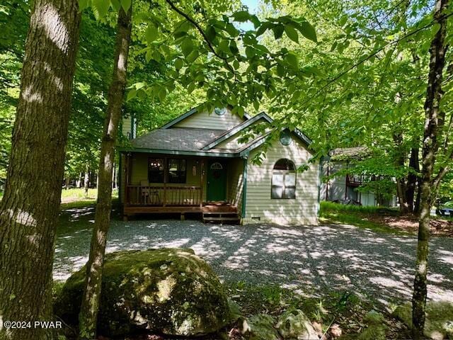 rear view of house featuring covered porch