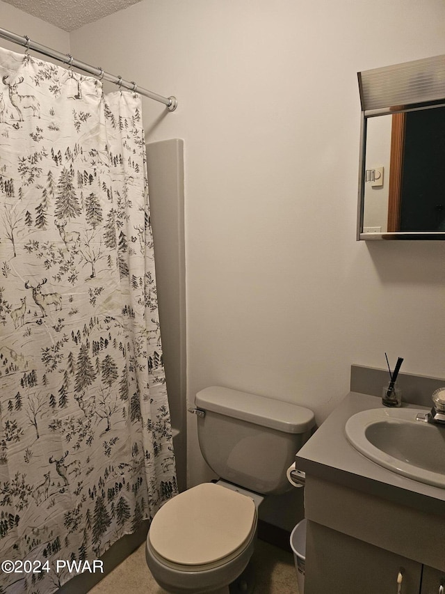 bathroom with a shower with curtain, toilet, a textured ceiling, and vanity