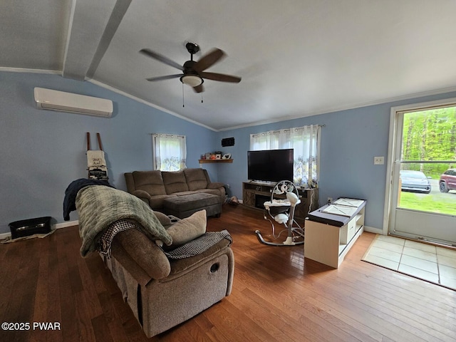 living area with a wall unit AC, ceiling fan, wood-type flooring, lofted ceiling, and healthy amount of natural light
