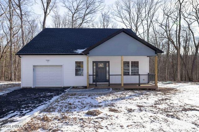 view of front of home with covered porch and a garage