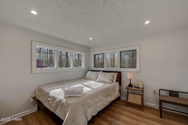 bedroom featuring dark wood-type flooring and a textured ceiling