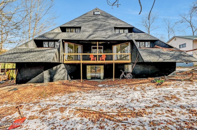 view of snow covered back of property