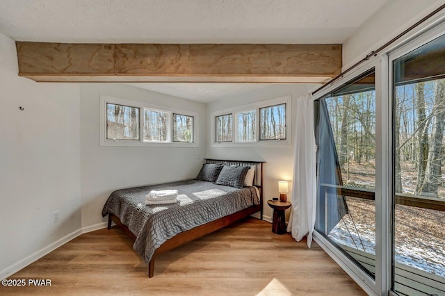 bedroom with light hardwood / wood-style flooring and a textured ceiling