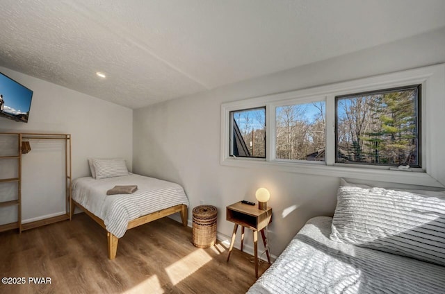 bedroom featuring lofted ceiling, a textured ceiling, and dark hardwood / wood-style flooring