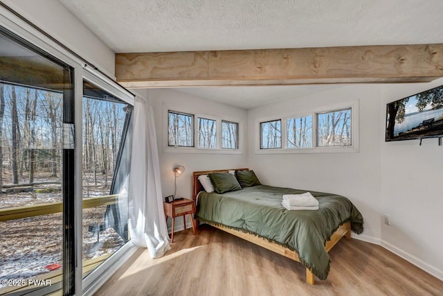 bedroom with wood-type flooring and a textured ceiling