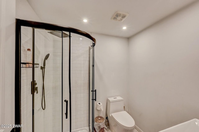 bathroom featuring toilet and a shower with shower door