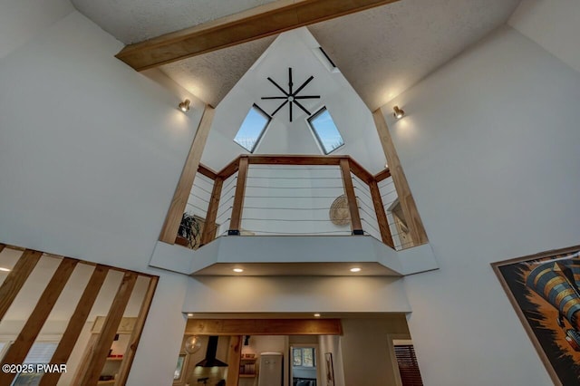 room details with beamed ceiling and a textured ceiling