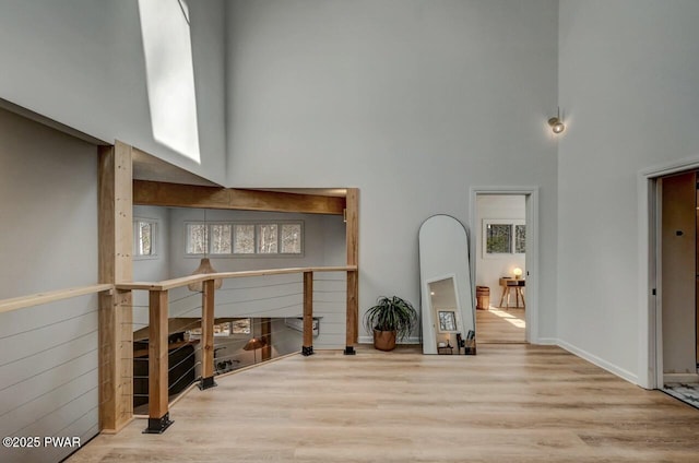 living room featuring a high ceiling and light hardwood / wood-style floors