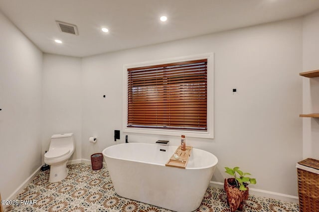 bathroom with toilet and a bathing tub