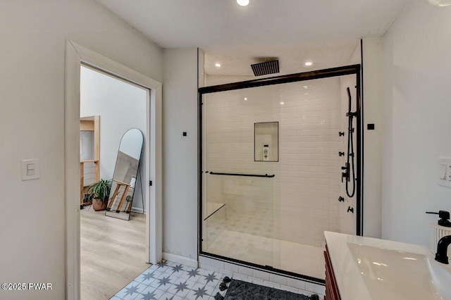 bathroom featuring walk in shower and vanity