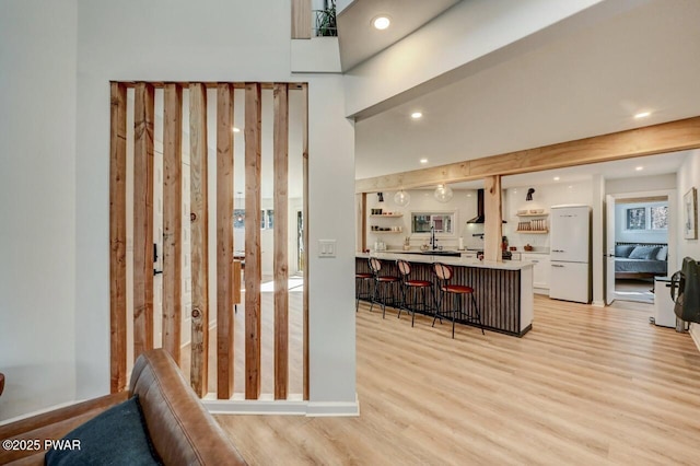 entryway with sink and light wood-type flooring