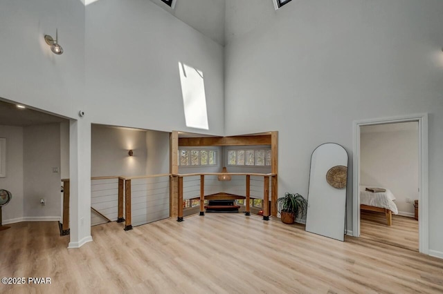 interior space with light hardwood / wood-style floors and a high ceiling