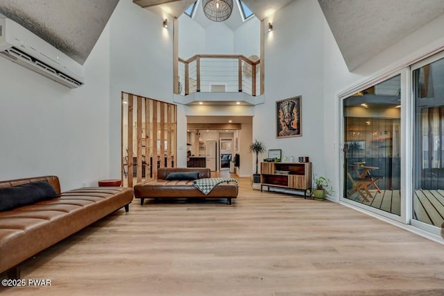 living room featuring a wall mounted air conditioner and light hardwood / wood-style flooring