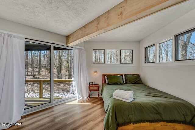 bedroom with hardwood / wood-style flooring and a textured ceiling