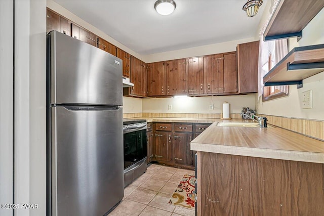 kitchen with sink, light tile patterned floors, and stainless steel appliances