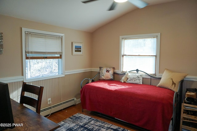 108 Juniper St, Dingmans Ferry, PA 18328 - bedroom with a baseboard heating unit, a wainscoted wall, wood finished floors, vaulted ceiling, and ceiling fan