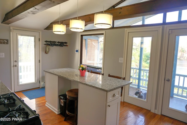 108 Juniper St, Dingmans Ferry, PA 18328 - kitchen with light wood-style floors, range with gas stovetop, white cabinets, and healthy amount of natural light