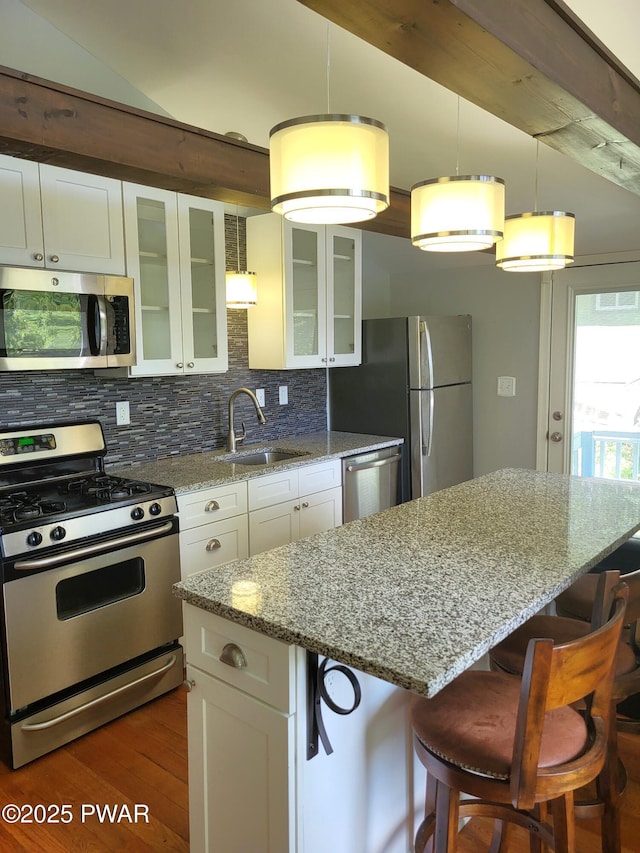 108 Juniper St, Dingmans Ferry, PA 18328 - kitchen with appliances with stainless steel finishes, dark wood-type flooring, a center island, white cabinets, and vaulted ceiling