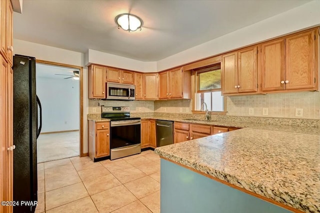 kitchen with ceiling fan, sink, backsplash, light tile patterned floors, and appliances with stainless steel finishes