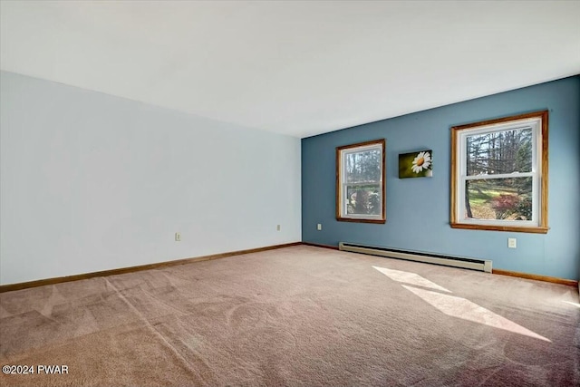 carpeted spare room with a baseboard radiator