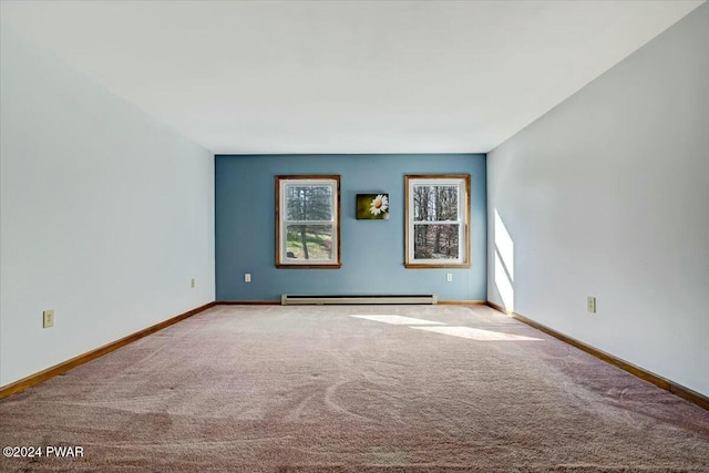 carpeted spare room with a baseboard radiator