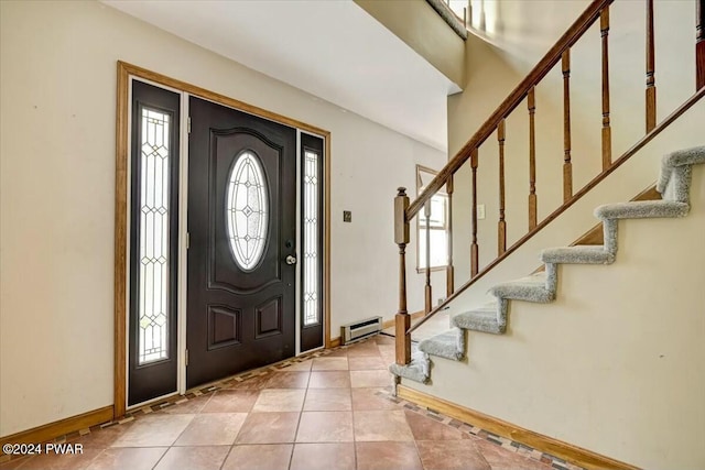 entrance foyer featuring baseboard heating and light tile patterned flooring