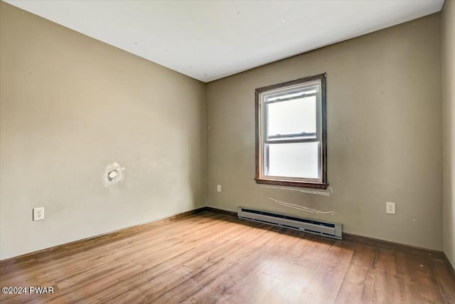 empty room featuring light hardwood / wood-style floors and baseboard heating