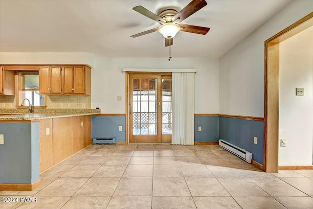 kitchen with light tile patterned floors, backsplash, ceiling fan, and a baseboard heating unit