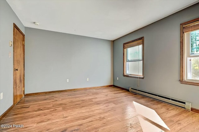 spare room featuring light hardwood / wood-style floors and baseboard heating