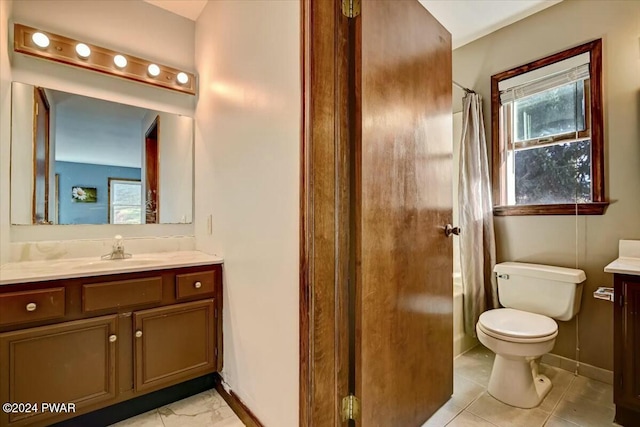 bathroom with tile patterned flooring, vanity, and toilet