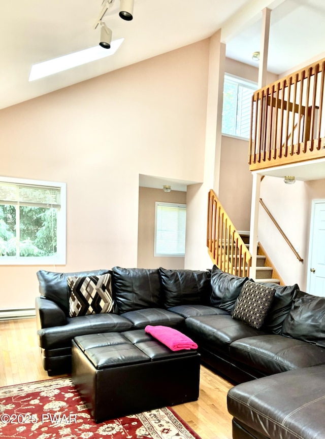 129 Skyview Rd, Dingmans Ferry, PA 18328 - living room with wood finished floors, healthy amount of natural light, stairs, track lighting, and high vaulted ceiling