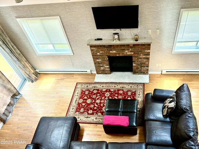 129 Skyview Rd, Dingmans Ferry, PA 18328 - living room with wood-type flooring, plenty of natural light, and a baseboard radiator